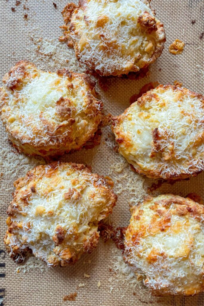 five cheddar buttermilk biscuits on a pan